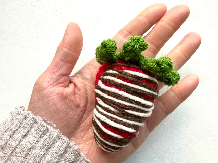 Hand-crocheted strawberry with a chocolate design, perfect for making a keychain, bag charm, or decorative accessory